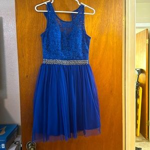 A blue sparkly top with sparkly waistband, but a short fitted dress